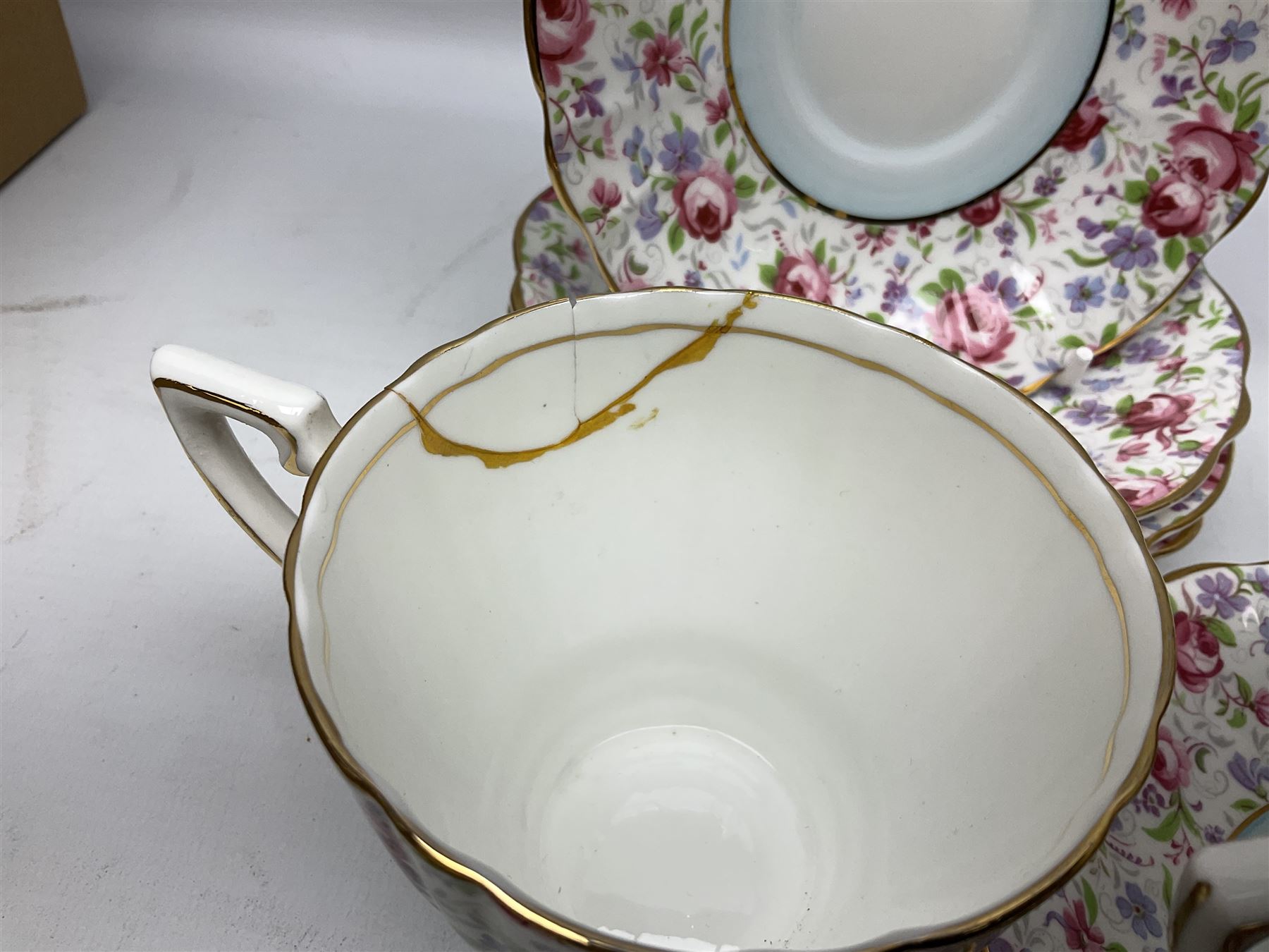 Windsor tea service for six decorated with blooming pink roses and purple flowers amongst foliage
