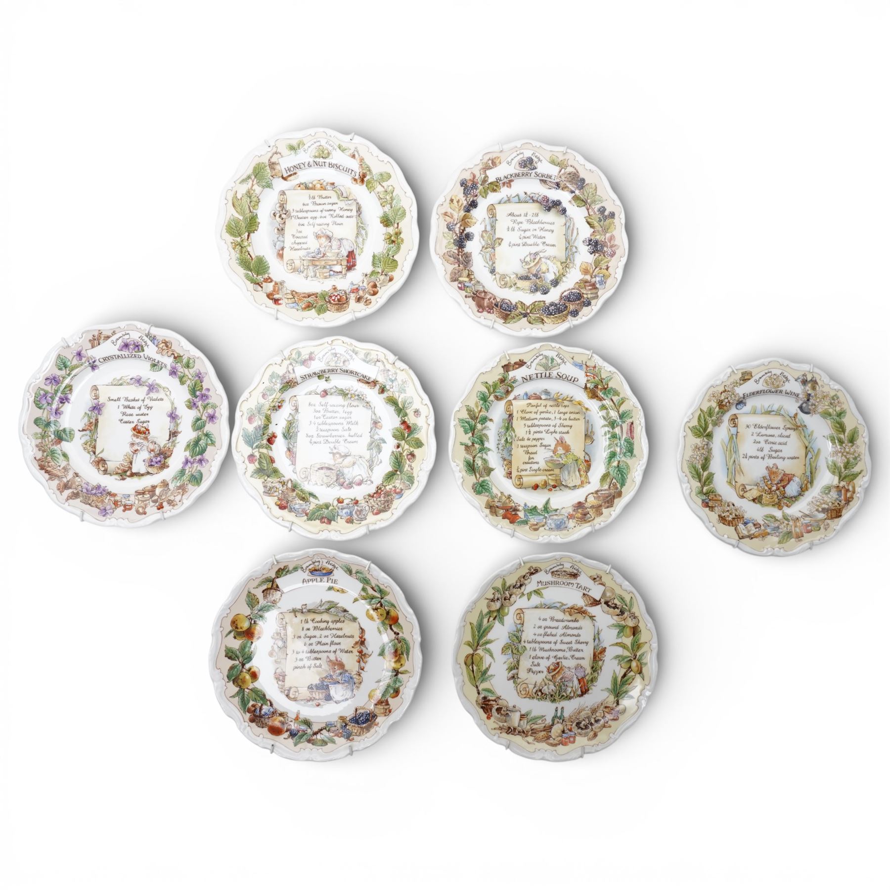 Eight Royal Doulton Brambly Hedge plates from the The Recipe Plate Collection, comprising 'Nettle Soup', 'Strawberry Shortcake', 'Mushroom Tart', 'Apple Pie', 'Elderflower Wine', 'Crystallized Violets', 'Blackberry Sorbet' and 'Honey & Nut Biscuits' (8)