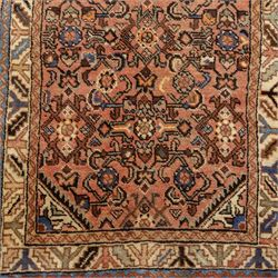 North West Persian Malayer hand-knotted runner, camel pink field decorated with an all-over lattice of Herati design, composed of rosettes and enclosed by angular leaves and stylized fish motifs, principal border of ivory ground decorated with stylized angular vine scroll and geometric palmettes, flanked by narrow guard stripes, with cotton fringe ends 