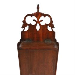 Three George III and later oak candle boxes, the first example of tapering form with shaped and pierced scroll crest, above a hinged lid, H50.5cm W18cm D13cm, the second of plain rectangular form with tapering crest, above a studded leather hinged sloped lid, H46cm W15.5cm D15.5cm, and third of plain rectangular form with demi-lune crest, with lift up front, H42.5cm W17.5cm D12cm 
