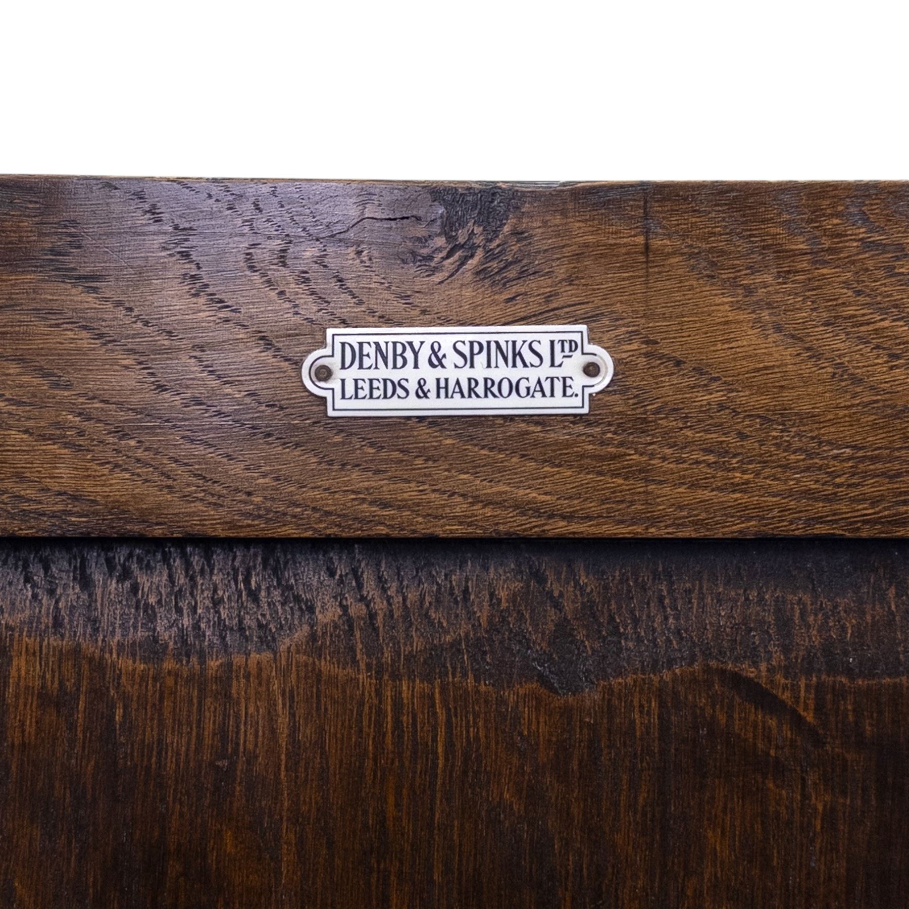 Mid 20th century oak double wardrobe, the rectangular top above twin panelled doors with carved linenfold decoration and wrought iron hinges, raised on block feet