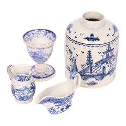 Group of 18th and 19th century ceramics, comprising 18th century pearlware tea caddy, if cylindrical form decorated with building and trees, H10.5cm, an 18th century blue and white pearlware saucer with similar decoration, D10.5cm, an 18th century creamware lozenge shaped boat, the interior painted with floral sprig, L12cm, and three pieces of 19th century blue and white transfer printed pottery, including a miniature jug decorated with the Playing Hoops pattern, H5.5cm, plus a Masons Bird and Flower pattern small octagonal basin, D10cm, (7)