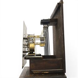 Early 20th century oak longcase clock, square brass dial with engraved foliate spandrels and centre, silvered Roman chapter ring with Arabic minute track, Westminster chime movement, the plain case with glazed arched trunk door and moulded plinth