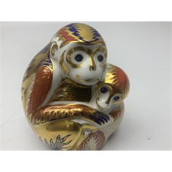 Three Royal Crown Derby paperweights, comprising Macaque, with gold stopper and original box, Monkey and Baby, with silver stopper and original box and Dragon with silver stopper, all with printed mark beneath  