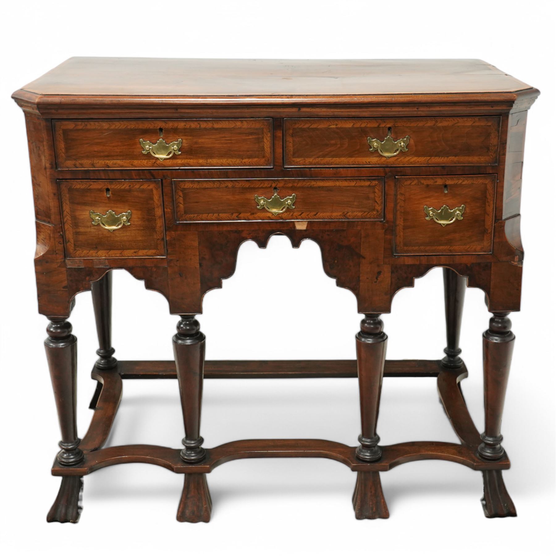 William and Mary design 18th century walnut and yew wood dresser or console table, rectangular canted top with feather banding and moulded edge, over two long and three short cock-beaded drawers, flanked by chamfered uprights above a shaped and cock-beaded apron, raised on six turned and tapering supports united by a shaped box stretcher, on lobed feet 