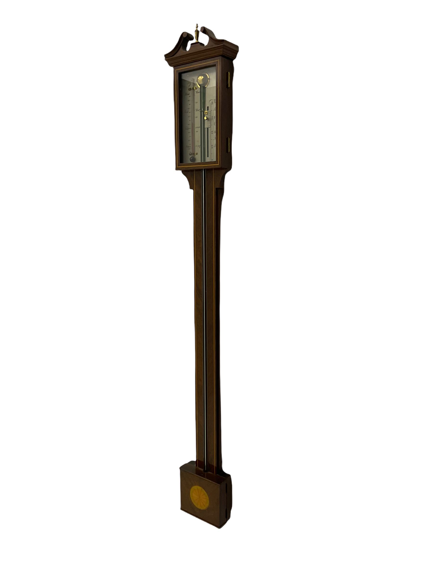A 20th century mercury stick barometer in an earlier 18th century style,
with a swan’s neck pediment and inlaid square cistern cover, enclosed silvered register with vernier and spirit thermometer, indicating barometric air pressure from 27 to 31 inches, with weather predictions and room temperature measured in both degrees Celsius and Fahrenheit. H70cm


