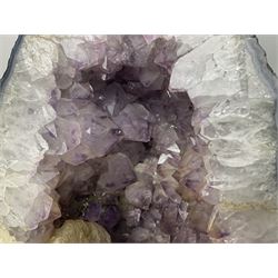 Amethyst crystal ‘cathedral’ geode, free standing with flat base and prepared outer surface, with well-defined crystals of various sizes within the cavern, H39, L32cm