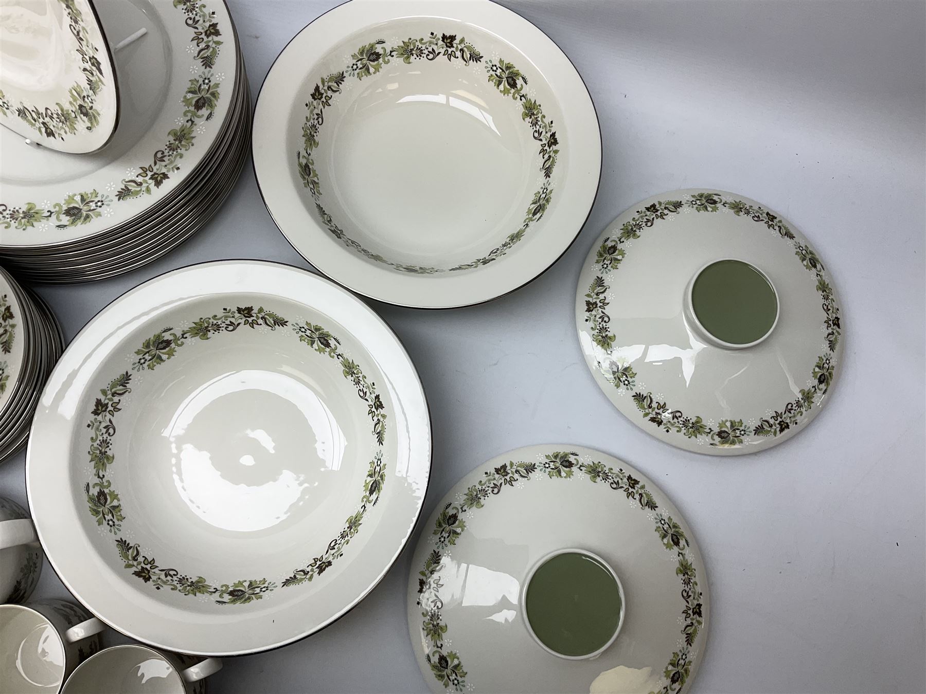 Royal Doulton tea and dinner wares decorated in the Vanity Fair pattern, to include twelve dinner plates, twelve side plates, eleven bowls, three lidded tureens, ten teacups, sauceboat on stand etc, together with boxed Royal Worcester plate, six Royal Worcester ramekins etc