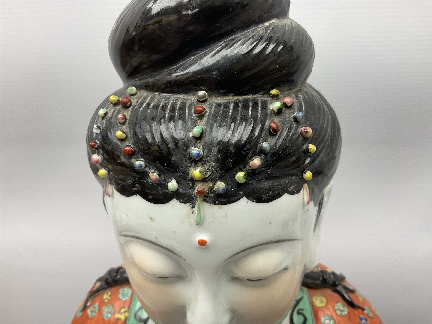 Tall Chinese polychrome figure of Guanyin (Guan Yin), the Goddess of Mercy and compassion, the Bodhisattva modelled seated and holding a rosary donning elaborate floral robes and beads, with four character seal marks beneath, H53cm