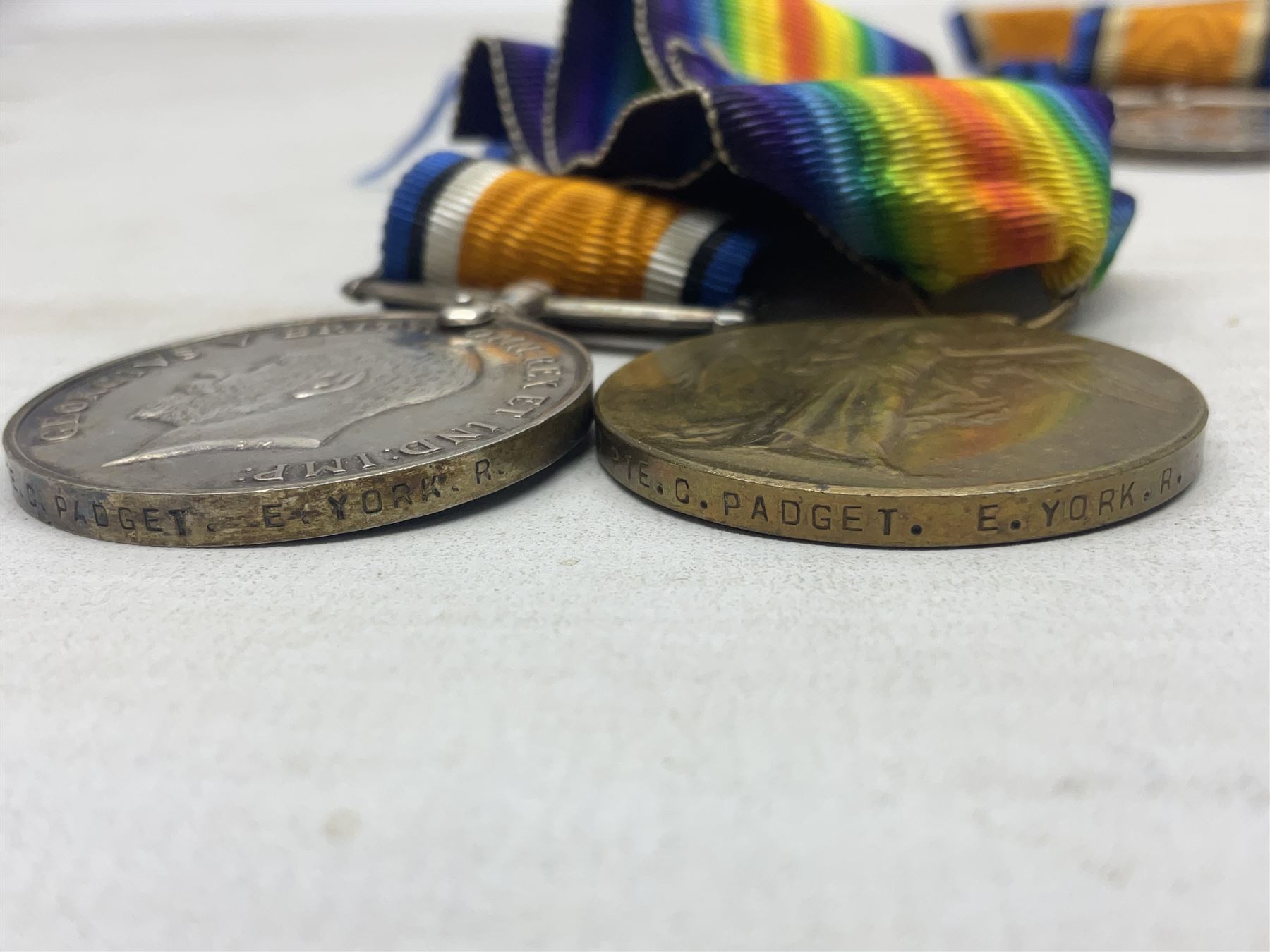 Family group of five WW1 medals for the East Yorkshire regiment comprising trio of 1914-15 Star, British War Medal and Victory medal awarded to 13-368 Pte. C. Padget; and British War Medal and Victory Medal to 201829 Pte. H.W. Padget; all with ribbons (5)