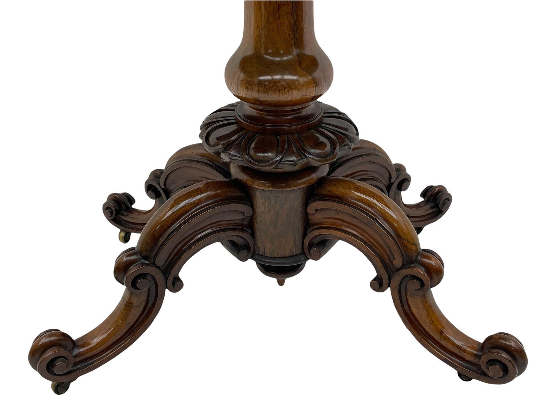 Victorian figured rosewood card table, fold-over swivel top with circular baize lining, moulded frieze with stylised flower head carving to corners, turned column with egg and dart decoration, on quadruple splayed c-scroll carved supports, with brass castors