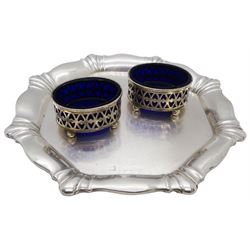 Pair of Edwardian silver open salts, each of oval form with pierced sides, upon four ball feet, with blue glass liners, hallmarked George Nathan & Ridley Hayes, Chester 1909, together with a 20th century silver waiter of octagonal form, hallmarks worn and indistinct, D16cm, approximate total silver weight 4.39 ozt (136.7 grams)