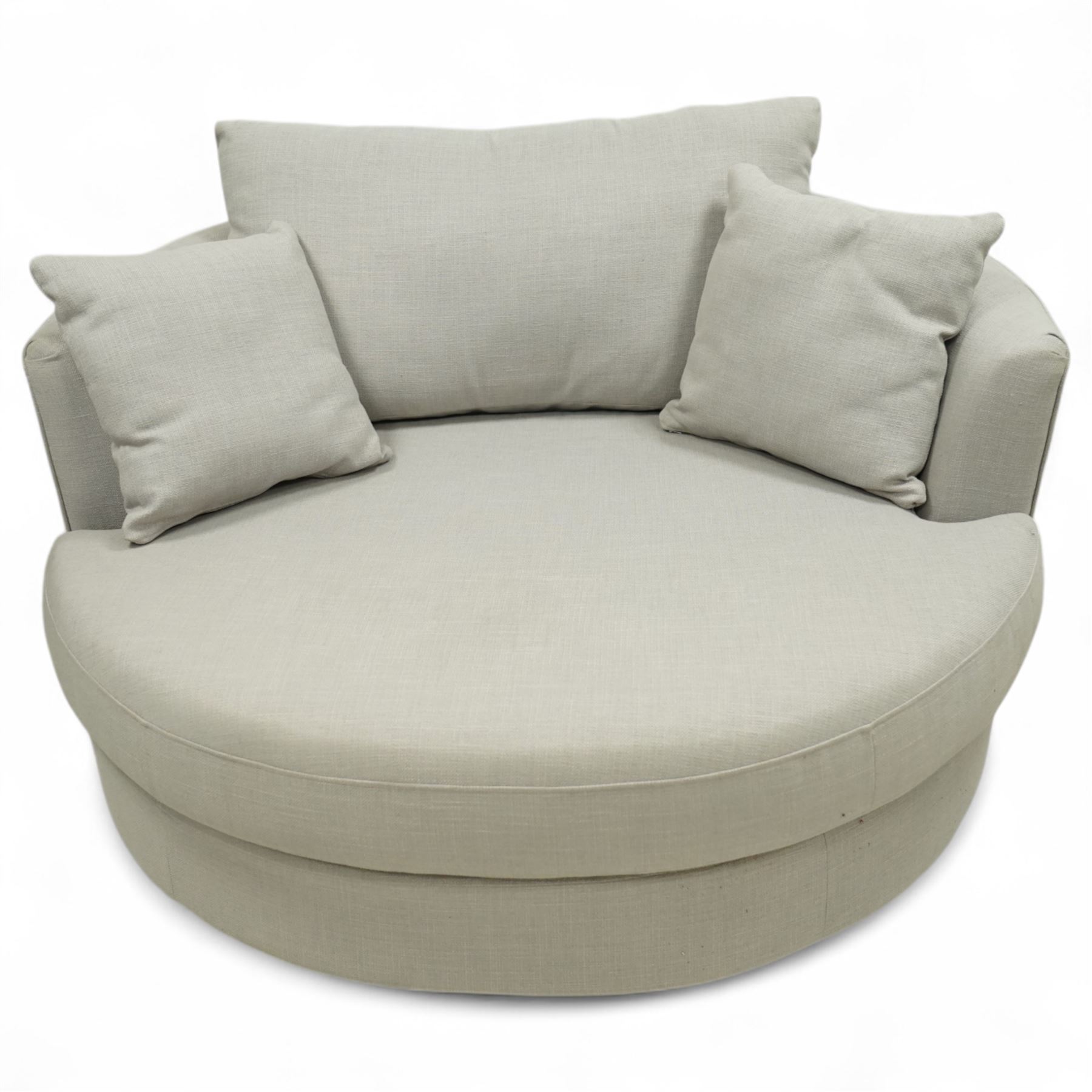 Contemporary circular snuggle chair, upholstered in taupe linen-effect fabric with fixed seat and loose back and scatter cushions, on concealed castors