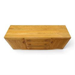 Ercol - mid-20th century light elm and beech Windsor 'model 455' sideboard, rectangular top over three central drawers flanked by cupboards, on castors