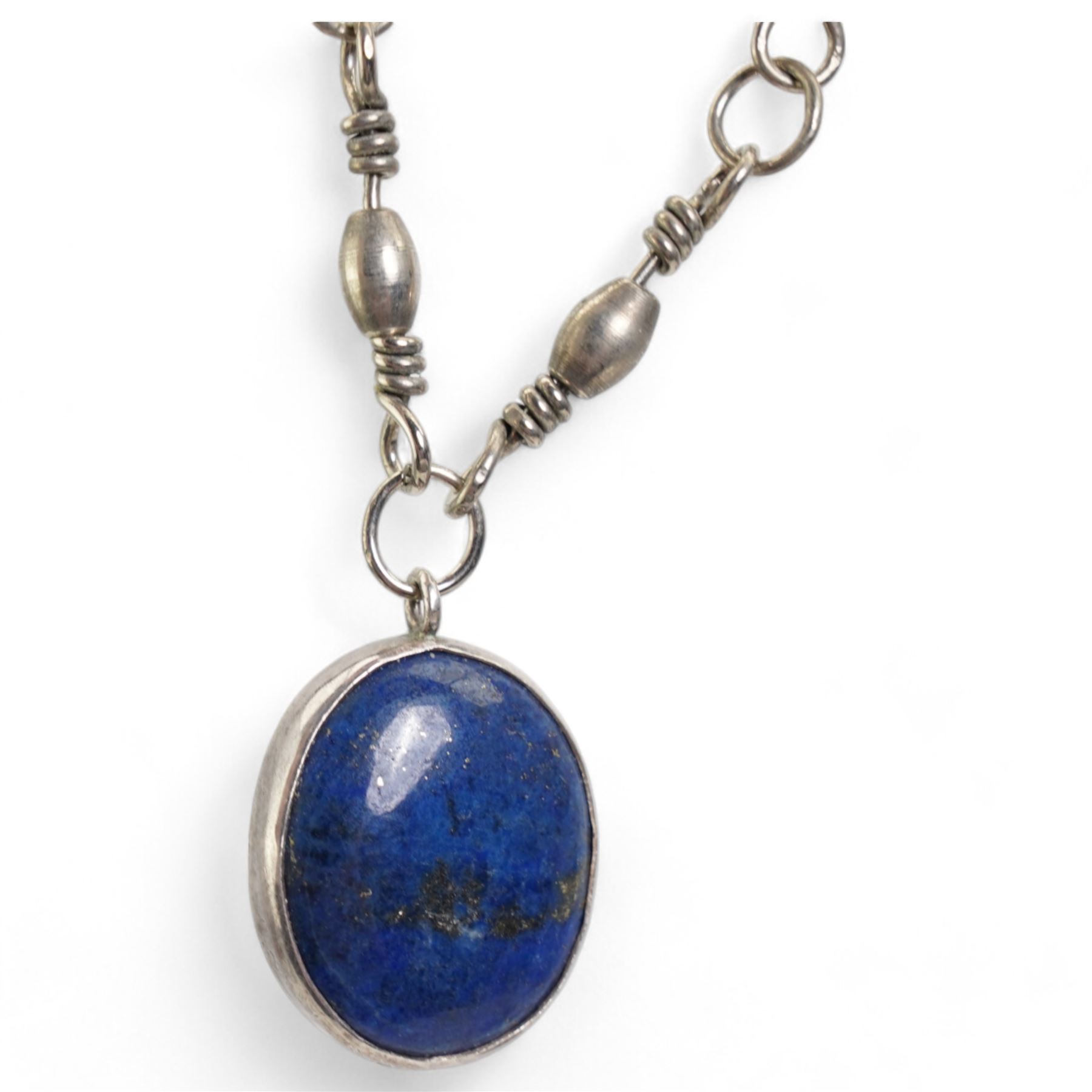 Early 20th century silver bell pendant, Birmingham 1915, on later silver chain, silver chain necklaces, silver garnet ring and a silver lapis lazuli pendant on white metal chain