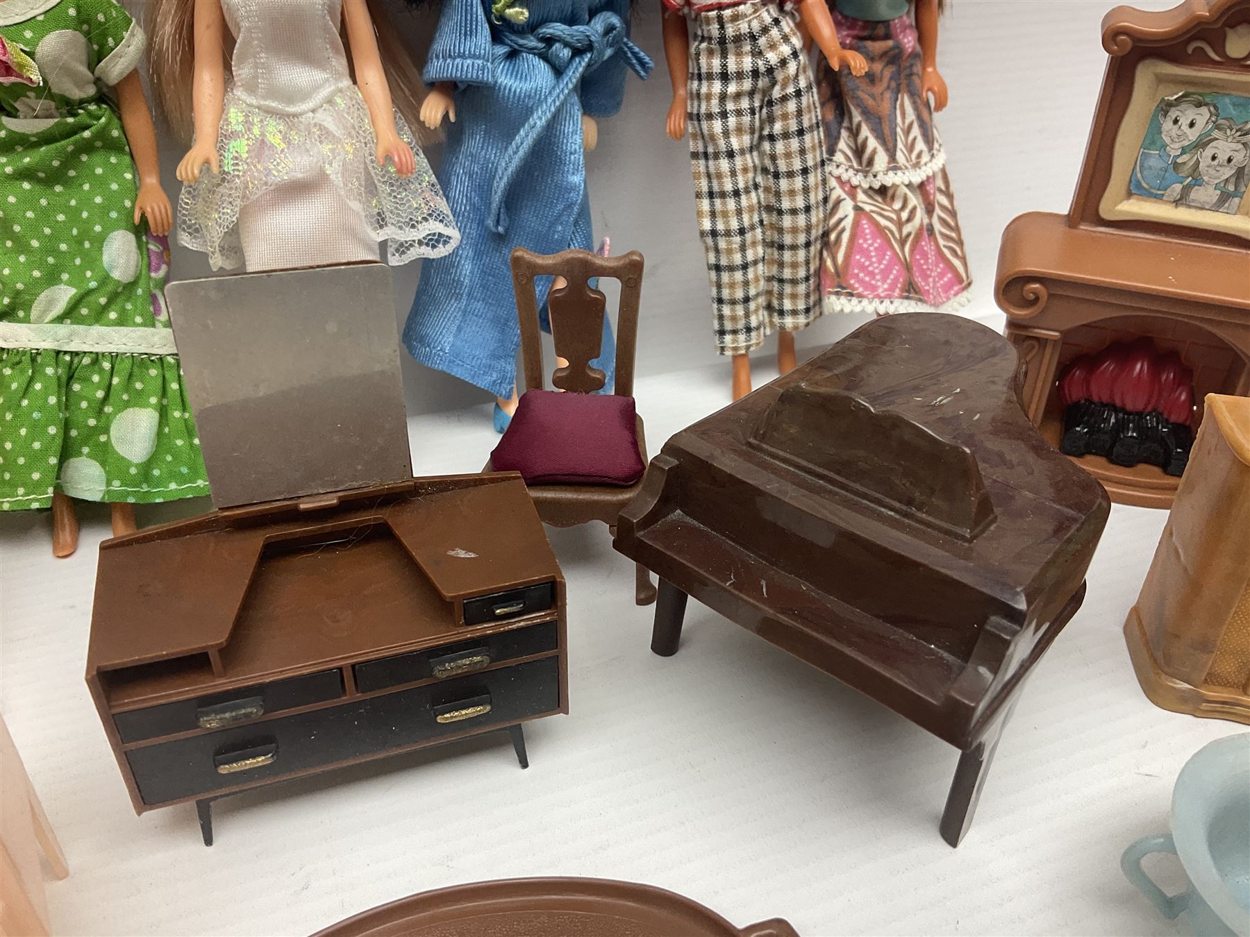 Seven Pippa dolls and a collection of plastic dolls house furniture