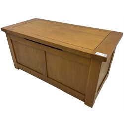 Oak blanket box, hinged lid over panelled front and sides 
