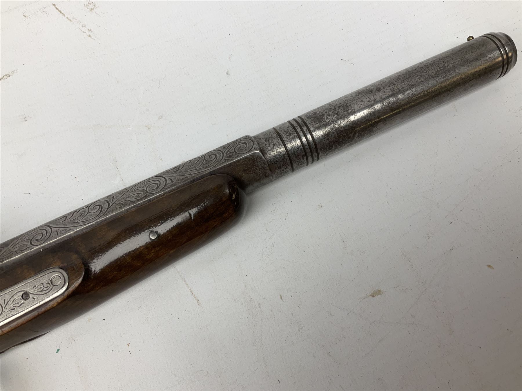 SECTION 1 FIREARMS CERTIFICATE REQUIRED OR REGISTERED FIREARMS DEALER - Pair of Reproduction Continental .44 calibre percussion target pistols, each with heavy 23.5cm octagonal to round barrel bearing various marks, crude scroll engraving to lock plate, hammer and octagonal section of barrel, unchequered walnut stock with brass butt plate and steel hooked trigger guard, numbered 8138 & 8164, L41.5cm overall; in maroon baize lined converted sapele mahogany fitted case bearing reproduction trade label for Trulock & Son Dublin containing small copper powder flask, steel scissor action bullet mould, nipple key, turned wooden mallet and lidded box, steel rammer and wooden cleaning rod, case L48cm