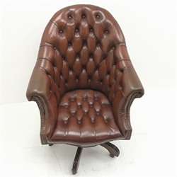 Library style swivel reclining desk chair, upholstered in deep buttoned and studded brown leather, five shaped supports, W78cm