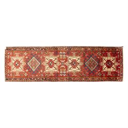 North west Persian Heriz runner, madder red field with a single column of alternating hook...