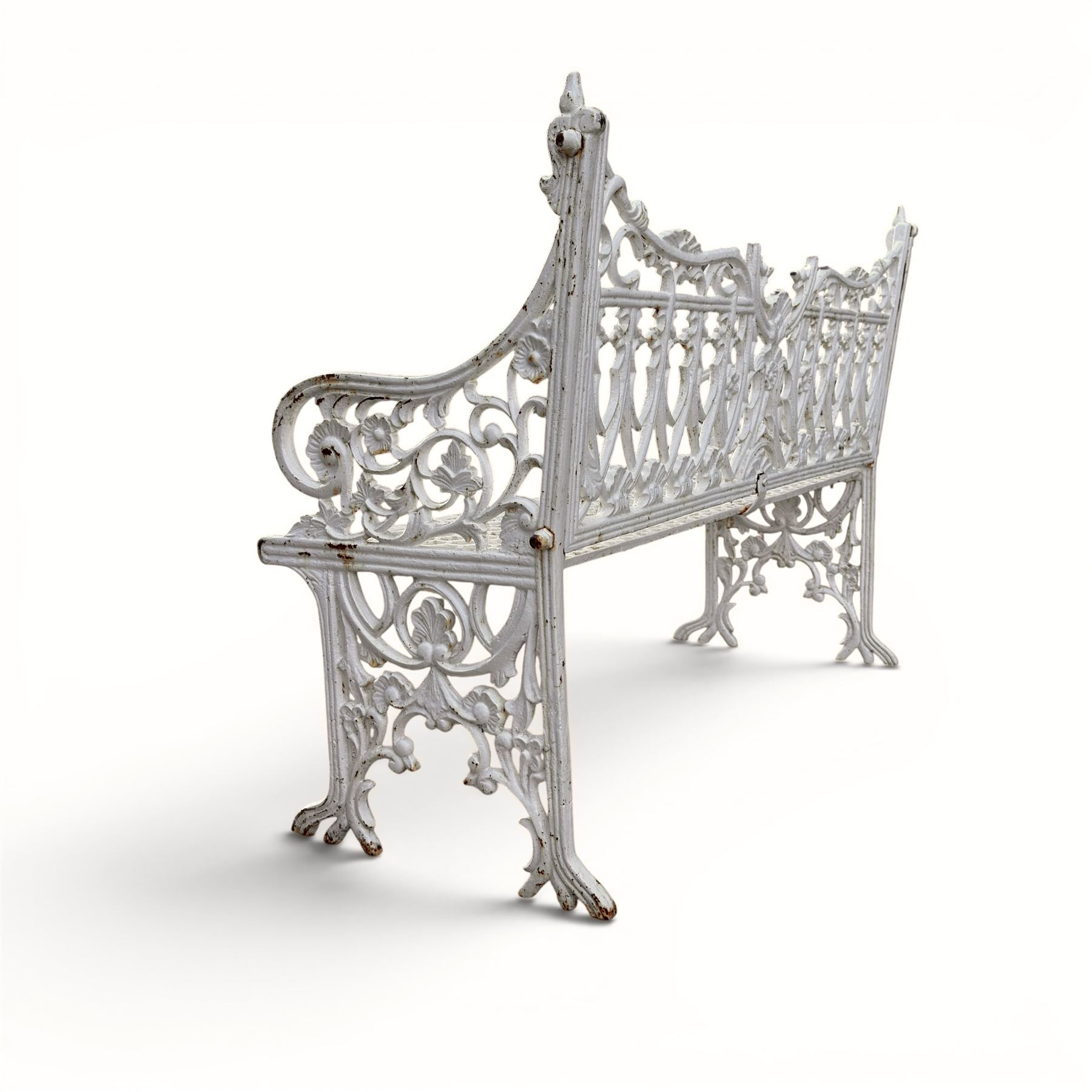 Victorian revival heavy cast iron garden bench, ornate back rest with scrolls, floral motifs and central crest, pierced lattice seat, curved arms and decorative legs, painted in antique white, in the Gothic Coalbrookdale style - Damaged 