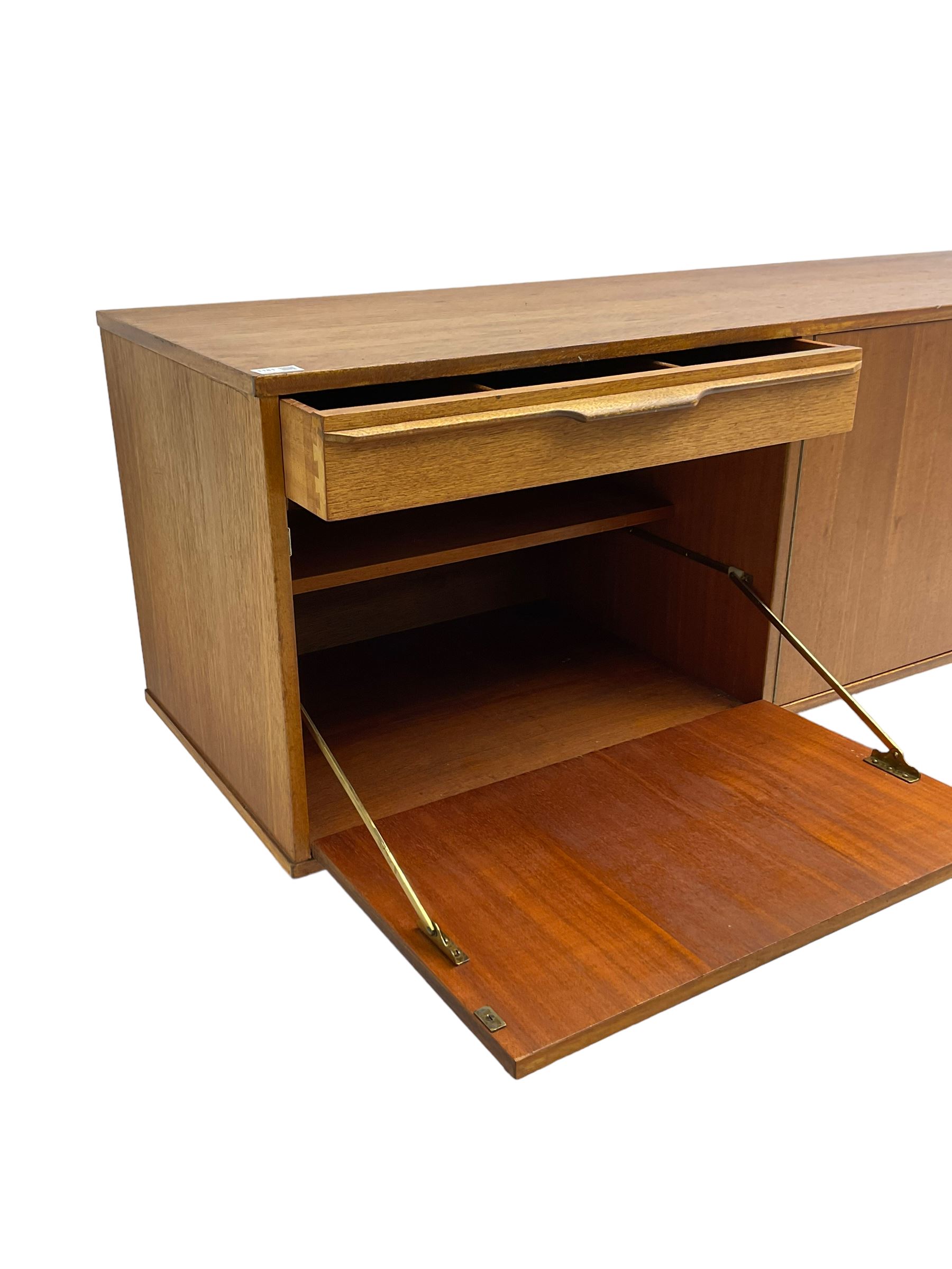 Morris of Glasgow - mid-20th century teak sideboard, fitted with double cupboard and single drawer above fall-front cabinet, raised on tapering supports