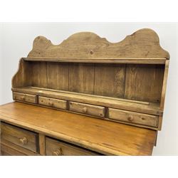 Traditional pine dresser, raised shaped back, fitted with one shelf and four short drawers, base unit fitted with two long drawers above two cupboards enclosing shelving, raised on platform base