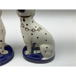 Collection of Staffordshire pottery, comprising pair of pen holders, modelled as recumbent greyhounds on blue washed cushion bases, together with a two pairs of seated dogs, one pair modeled as dalmatians and a house