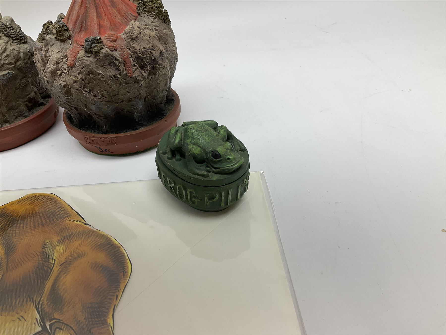 Terry Pratchett Discworld figures, designed by Clarecraft, comprising Death and Granny Weatherwax, DW90, Deathhead DWE8, Dried-frog pill box, boxed, DW63, Death as Beau Nidle, boxed, DW88, Agnes Nitt DW68, Detritus, DW22, Bonsai mountain, DW78, Volcanic bonsai mountain, boxed, DW79, Bonsai mountain valley, DW80, together with the Discworld mapp, and a collection of Terry Pratchett cards.  