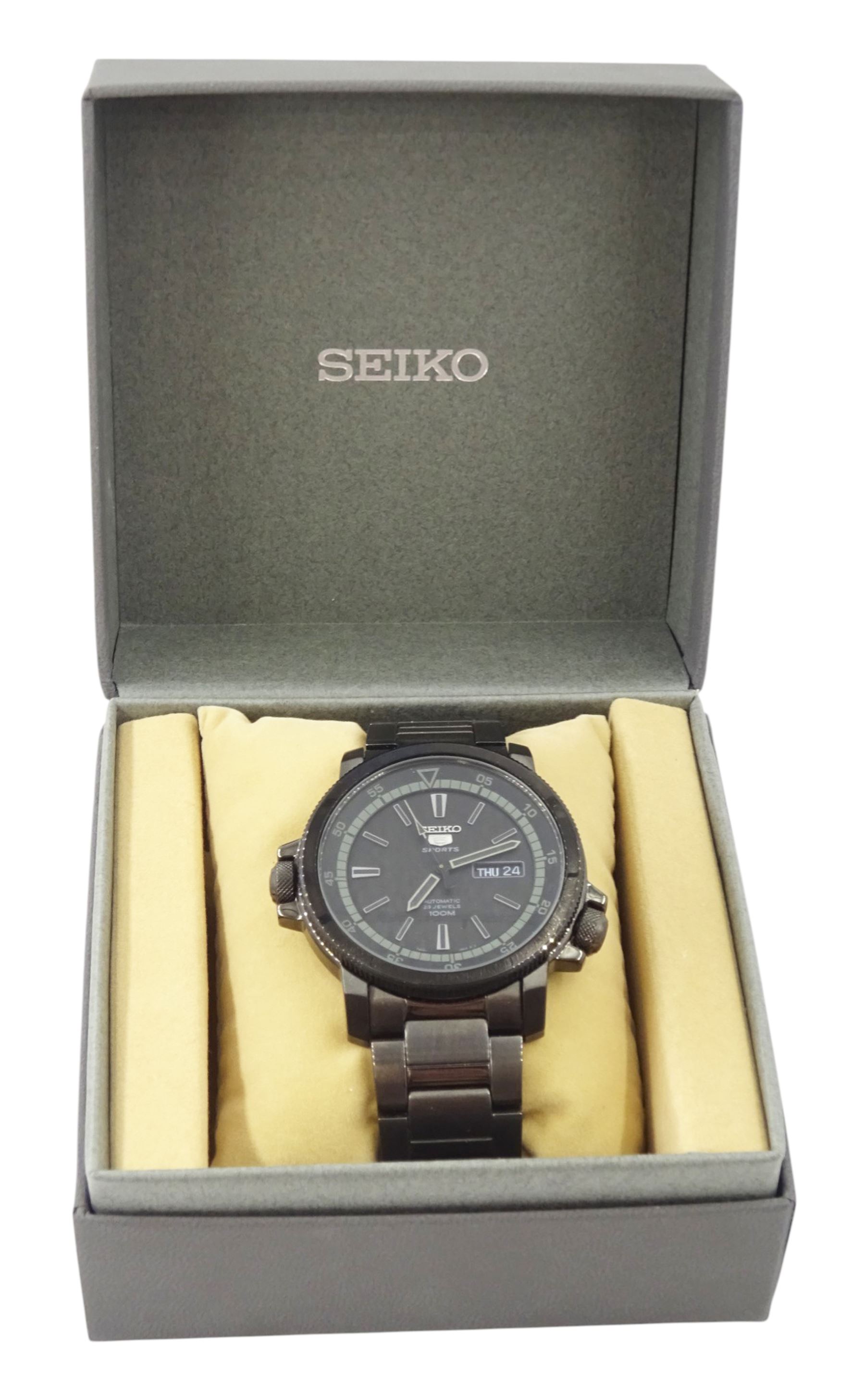 Seiko 5 Sports gentleman's stainless steel automatic wristwatch, Ref. 7S36-04N0, black dial with gilt baton hour markers and one other Seiko 5 Sports, Ref. 7S36-04X0, with grey dial and baton hour markers, both with day-date apertures and exhibition back cases, one boxed
