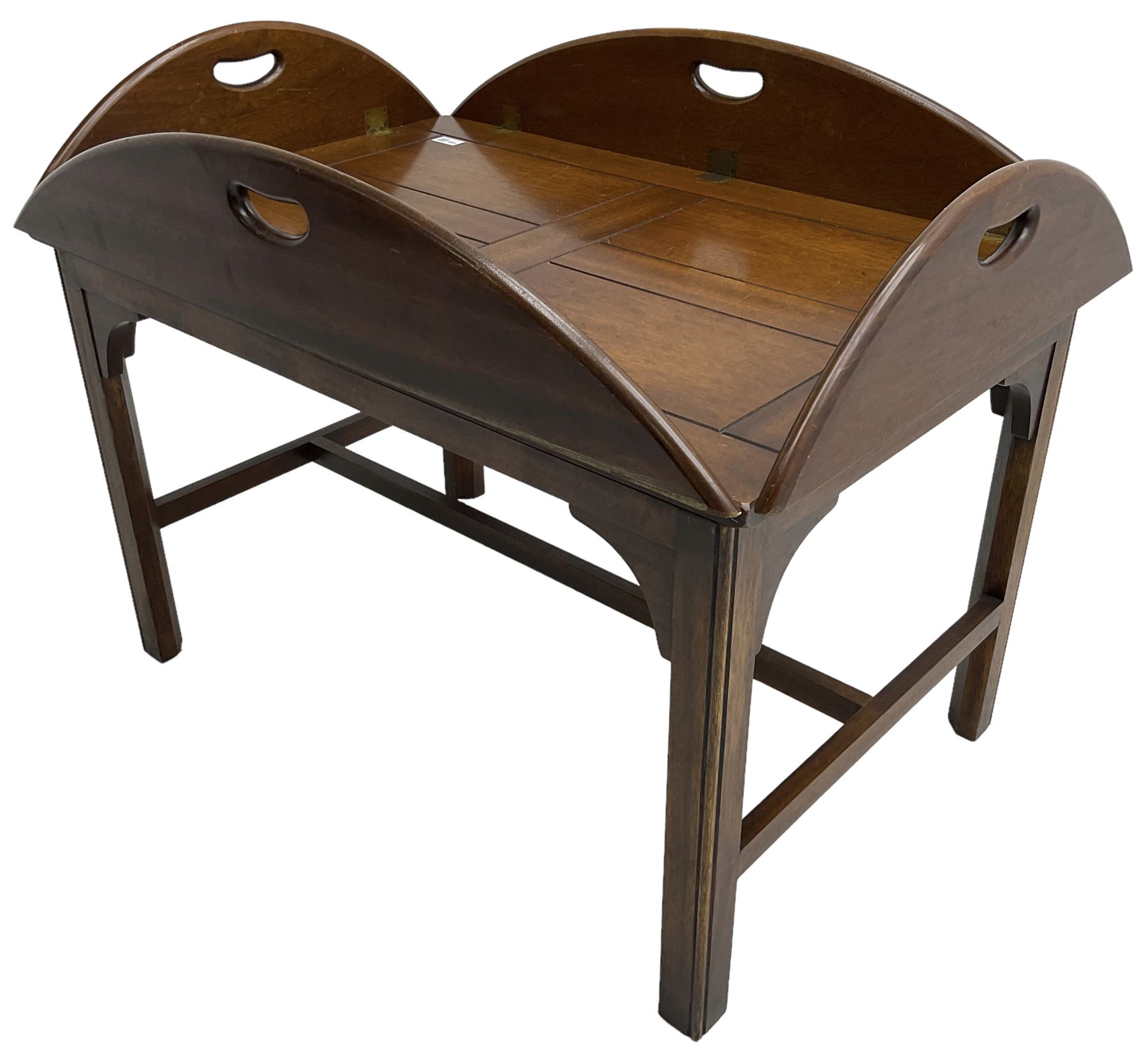 Mahogany butler's tray top coffee table, the removable tray with hinged sides and ends pierced with handles, on square moulded supports united by H stretcher 