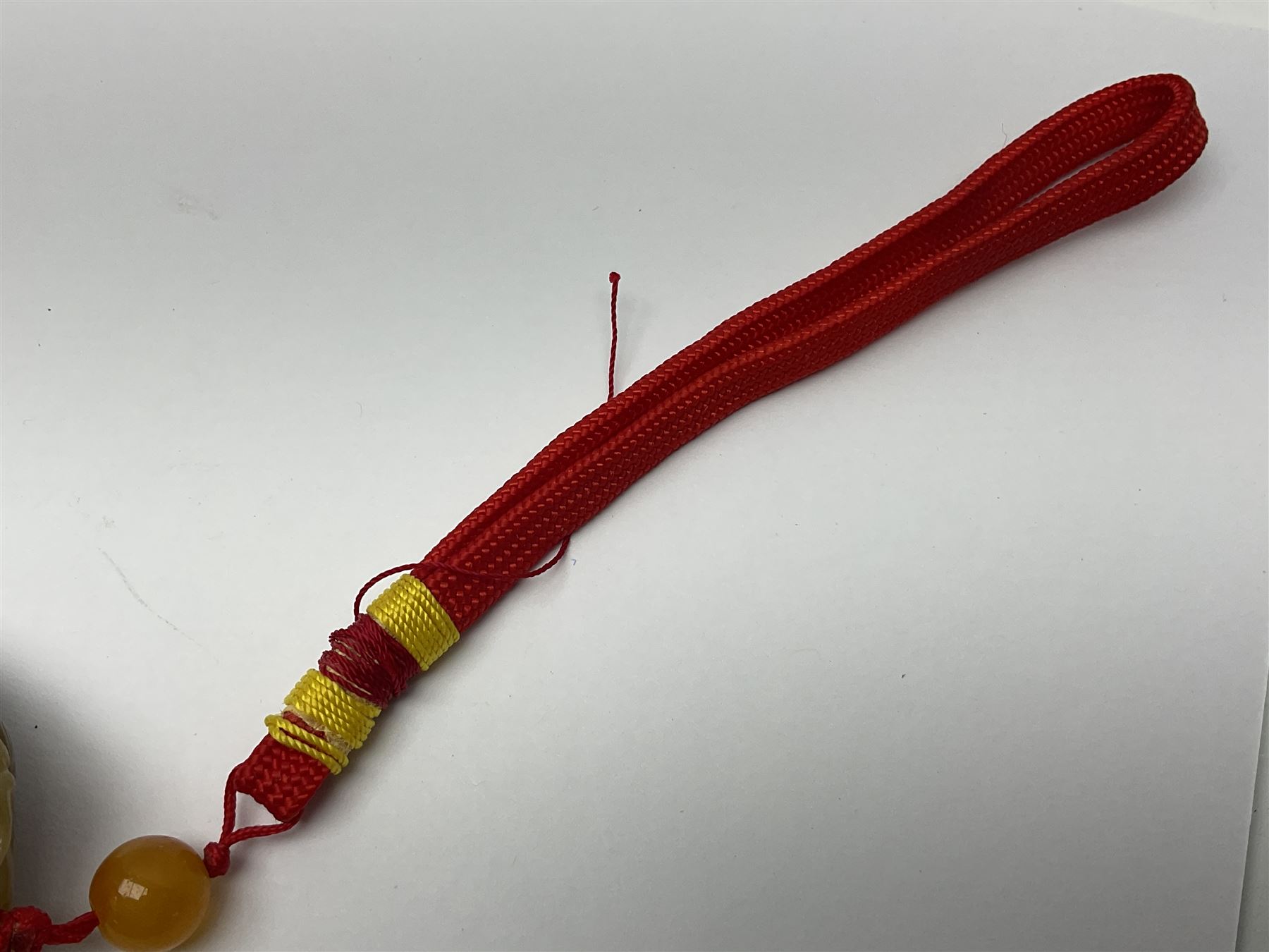 Chinese hardstone carving of a fish amongst coral, with platted rope handle, together with other hardstone and soft stone carvings  