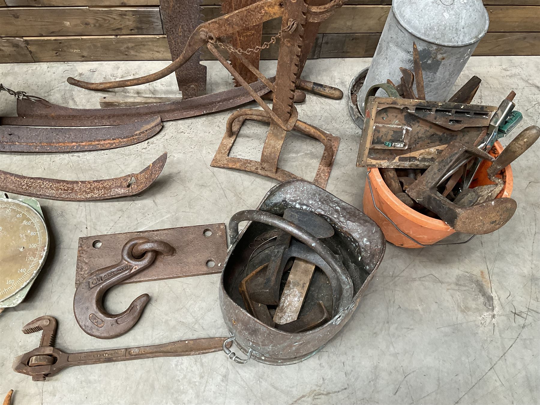 Large quantity of vintage hand tools including scales, scythes, saws etc