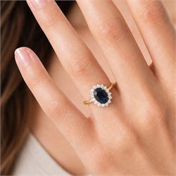 18ct gold sapphire and diamond cluster ring, single oval cut sapphire of approx 2.60 carat, surrounded by sixteen round brilliant cut diamonds, hallmarked, total diamond weight approx 0.45 carat