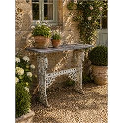 Victorian ornate cast iron garden table, trefoil base with central enclosed column, circul...