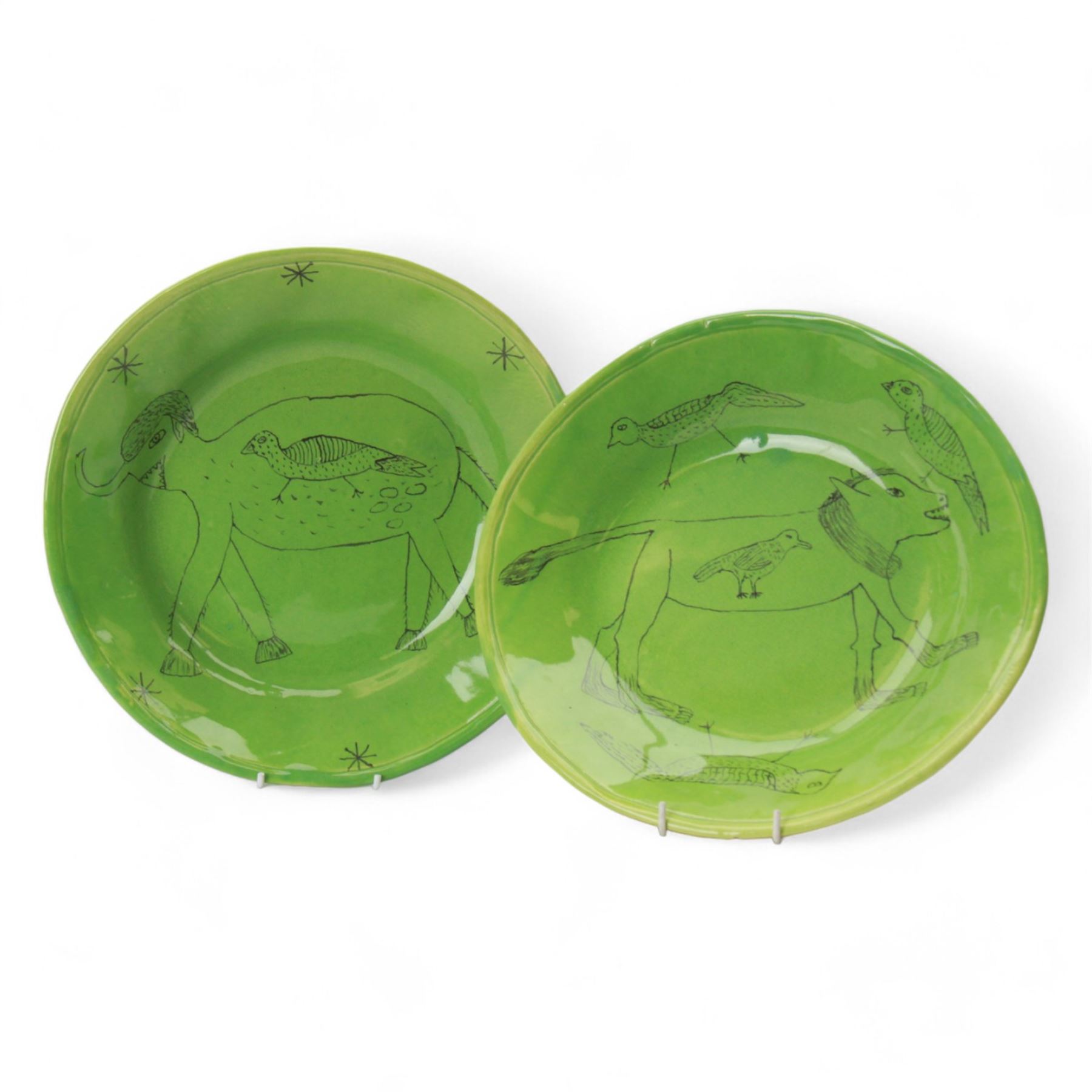 Hylton Nel (1941-); Two bowls, 1995, the green ground decorated internally stylised animals and birds, with makers mark and date to the base HN. 17.5.95