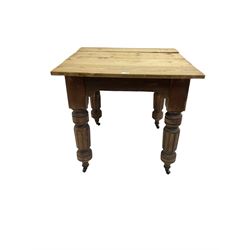 Edwardian pine and walnut dining table, square top over turned and fluted supports on castors