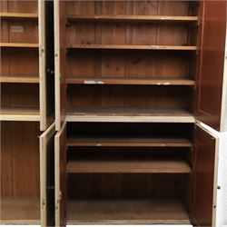 Large Georgian painted pine housekeepers cupboard, projecting cornice with four sets of twin cupboard doors with shelving enclosed