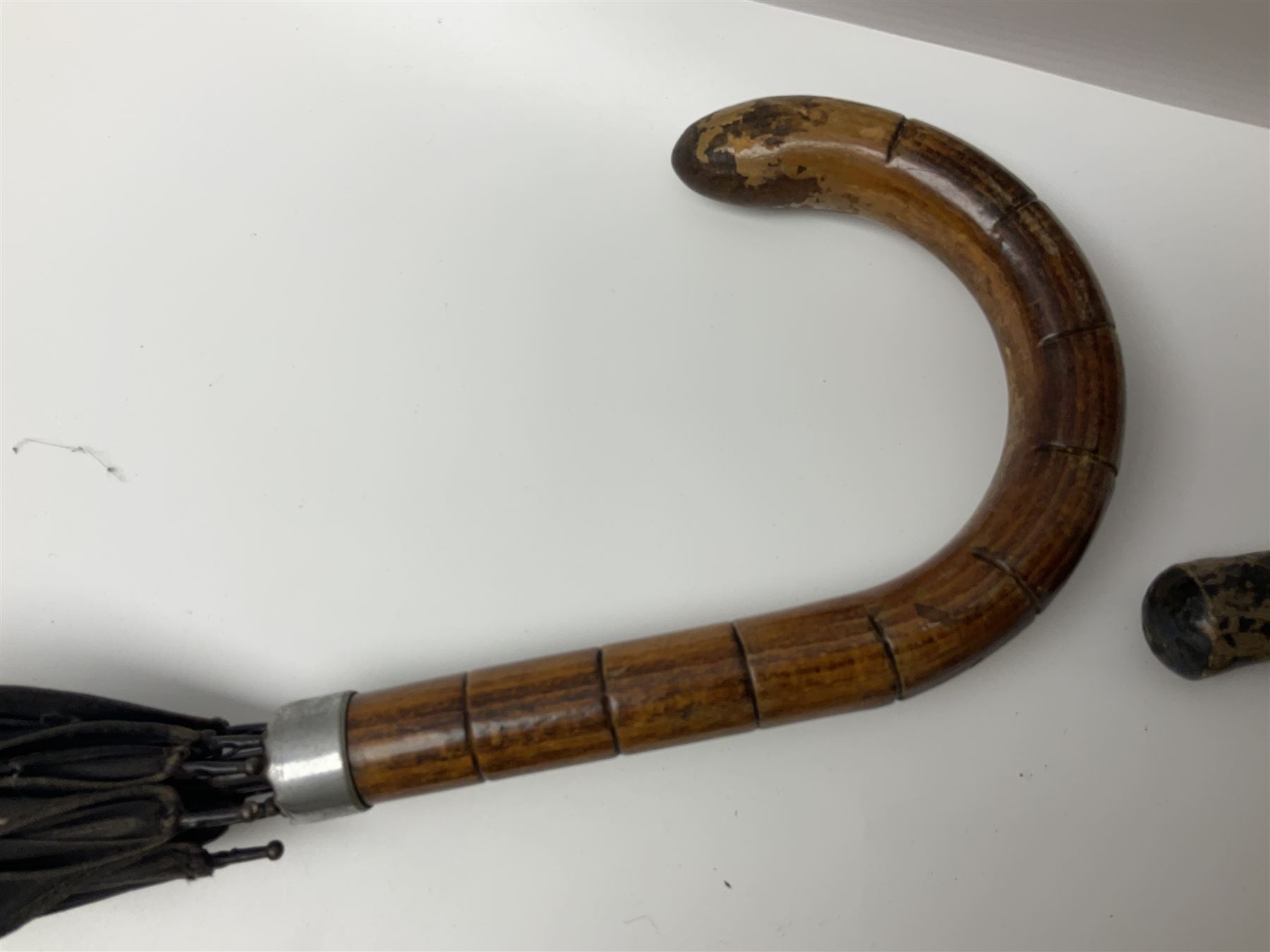 Early 20th century curved horn handle walking stick with hallmarked silver mounts, engraved L Russell 1918, together with a shooting stick by William Mills Birmingham, with leather handle, 'The Featherwaite' shooting stick and an umbrella with wooden handle