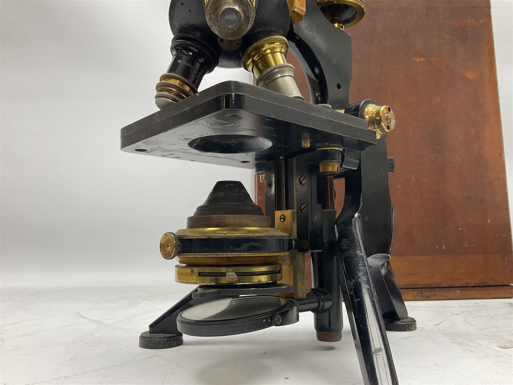 19th century brass and black japanned monocular microscope by W. Watson & Sons Ltd. 313 High Holborn, London serial no.24788 with rack and pinion focussing on tripod base H31cm; in fitted mahogany case retailed by A.H. Baird Scientific Instrument Makers Edinburgh; quantity of additional lenses and accessories; together with another similar uncased monocular microscope by W. Watson serial no.58379 (2)