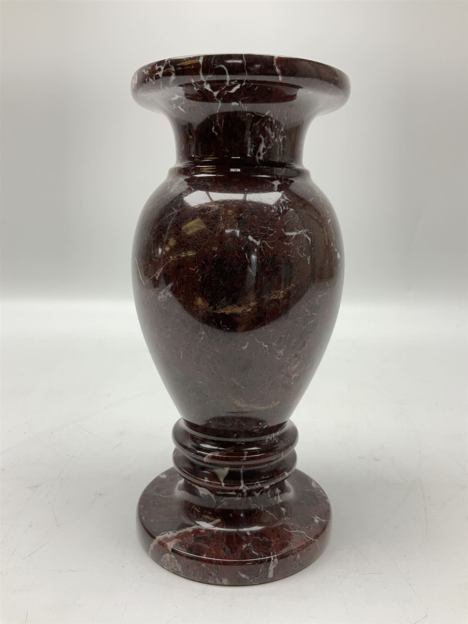 Red marble vase, of baluster form upon a stepped foot, H20cm 