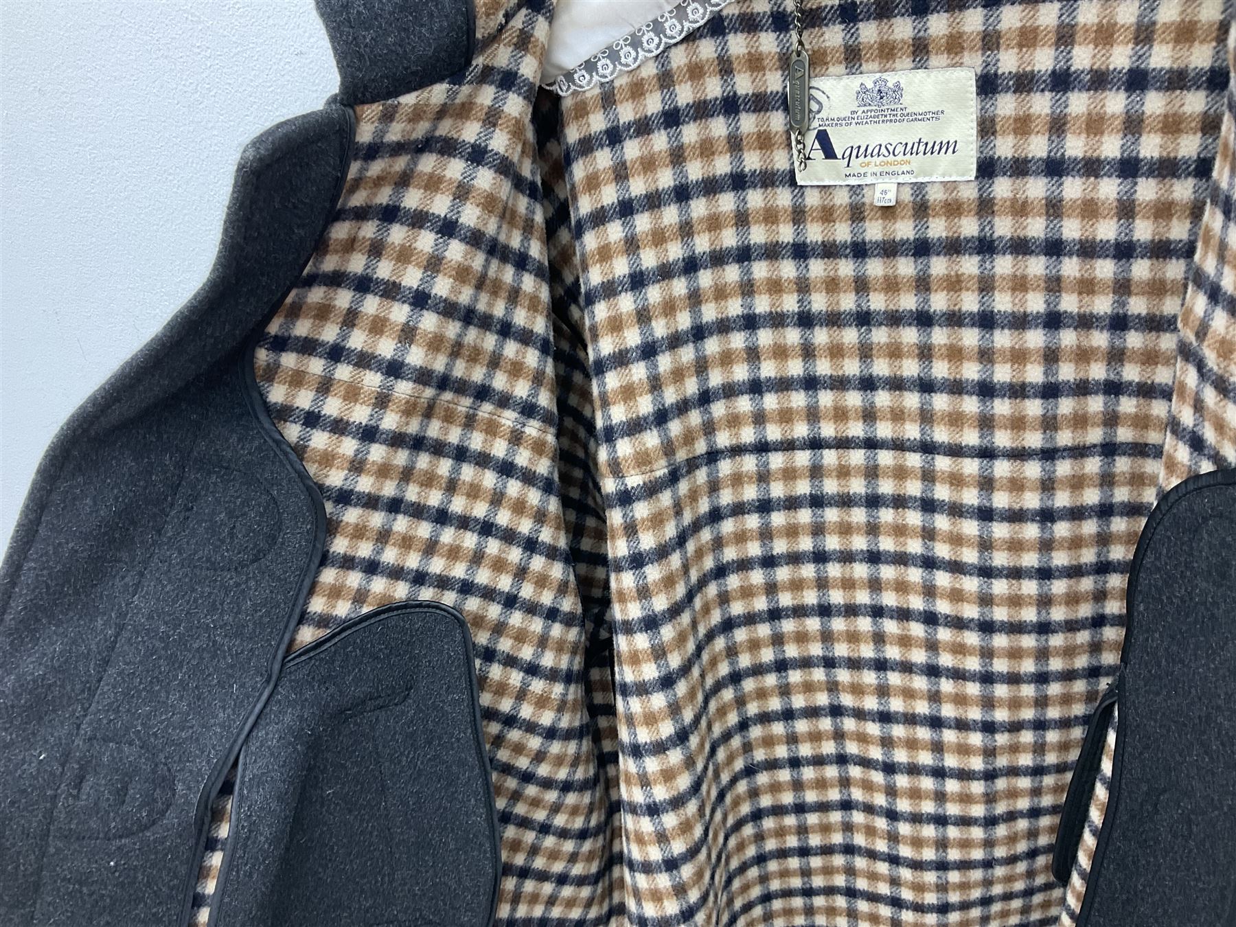 Men's Aquascutum lambs wool herringbone tweed coat with silk lining, 46 Reg, together with a further Men's Aquascutum grey wool duffle coat, with cheque lining and horn buttons, 46