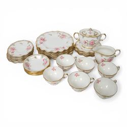 Modern Royal Crown Derby tea set for six place settings, decorated in the Royal Pinxton Roses pattern, comprising tea cups, saucers, small dishes, side plates, dessert plates, one serving plate, twin handled lidded sucrier and milk jug