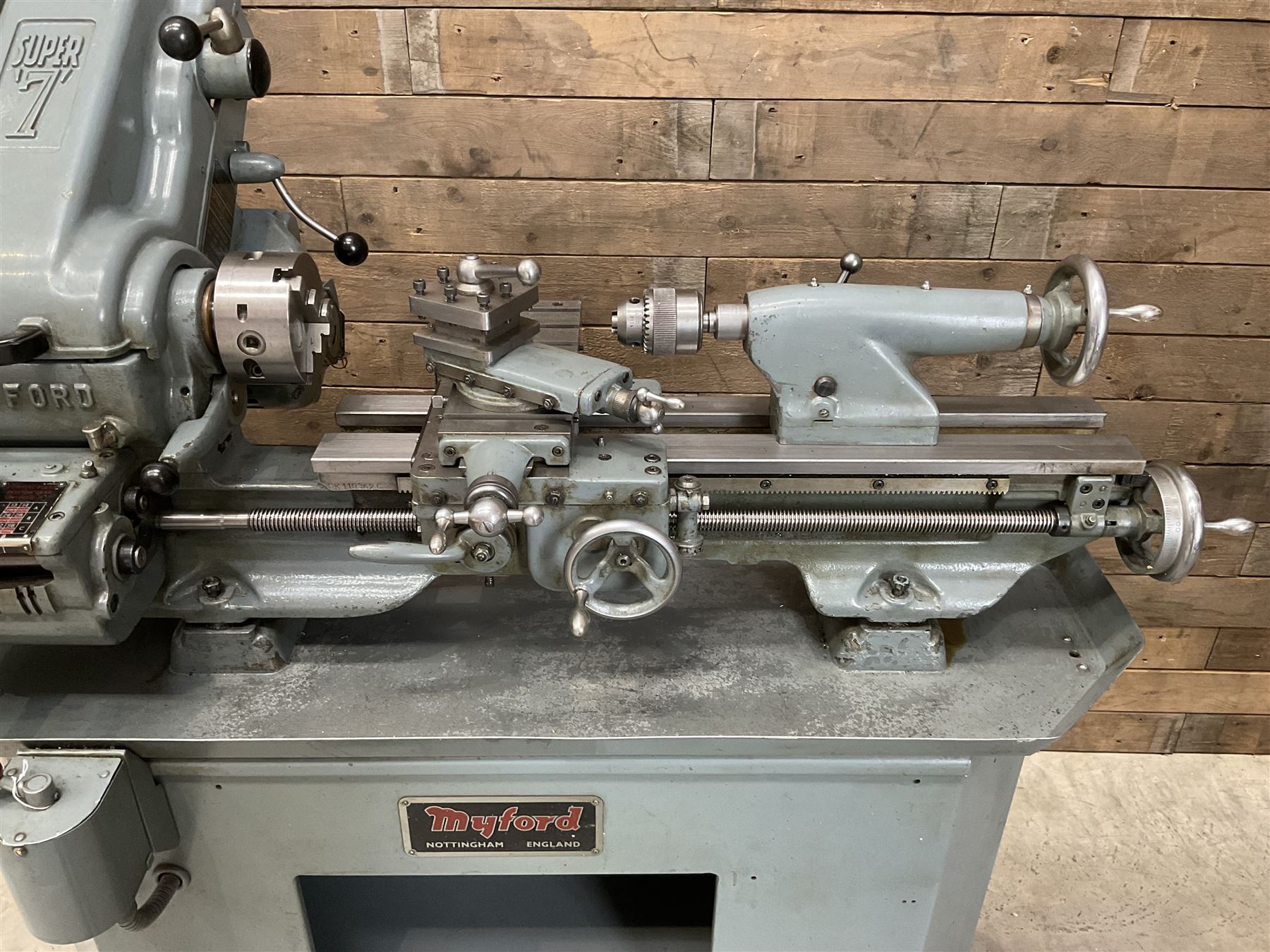 Myford Super 7 metal turning lathe with extensive collection of attachments, chucks, collets, bits; and precision metal saw