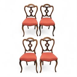 Set of four Victorian walnut balloon back chairs, with a carved and pierced back splat wit...