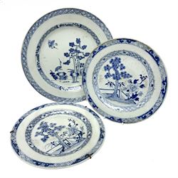 Late 18th/early 19th century Chinese export blue and white plate, of circular form decorated with pine tree and three cranes, together with a pair of smaller examples decorated with pine tree, peony and fence, each within foliate and trellis borders, largest example D28.5cm, smaller pair D23cm 