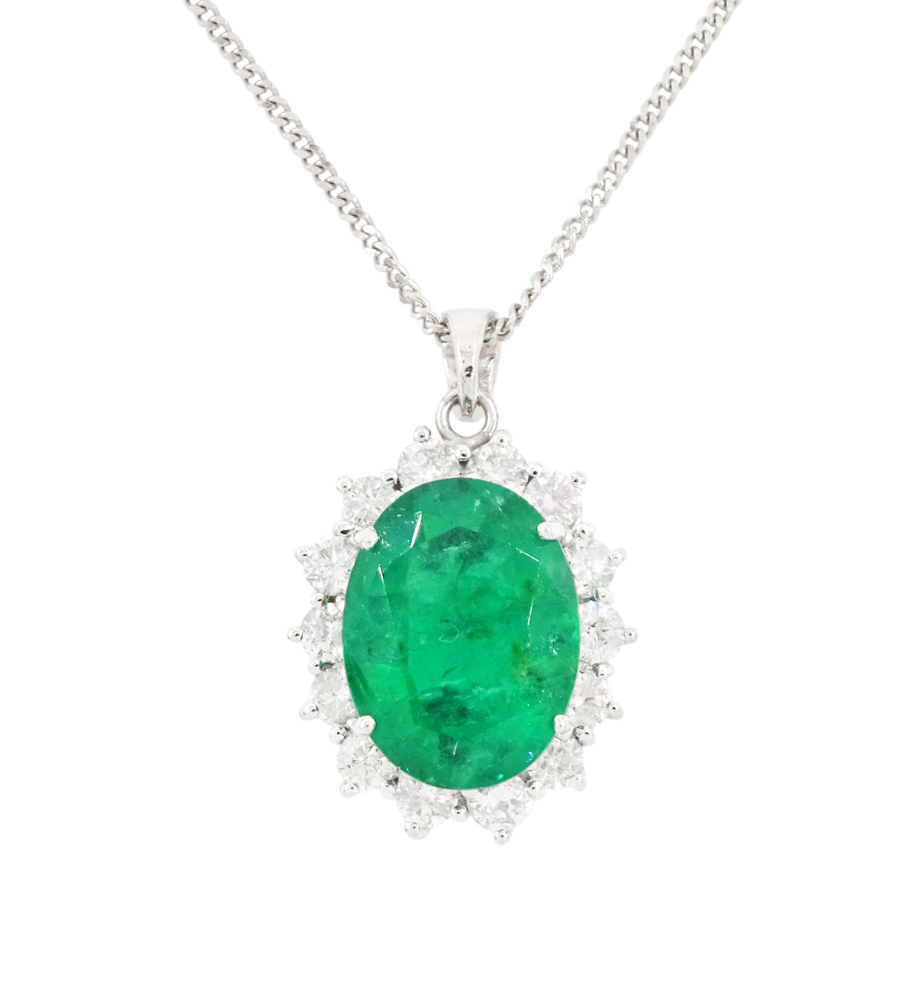 18ct white gold emerald and diamond pendant necklace, single oval cut  emerald of approx 3.25 carat, surrounded by fourteen round brilliant cut diamonds, on a fine link chain necklace, hallmarked, total diamond weight approx 0.50 carat