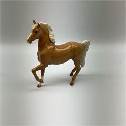 Beswick Palomino prancing Arab model no 1261, together with a Palomino foal model no 815, both with printed mark beneath.  