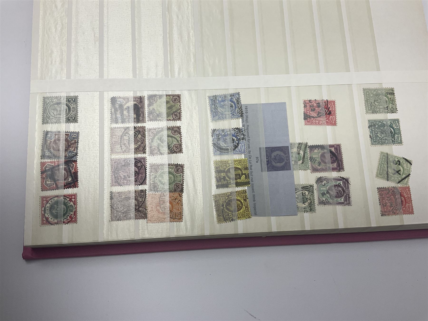 Mostly Great British stamps, including King Edward VII two shillings and sixpence, five shillings and ten shillings, King George V seahorses, King George VI high values, Queen Elizabeth II pre and post decimal etc, housed in a pink stockbook 
