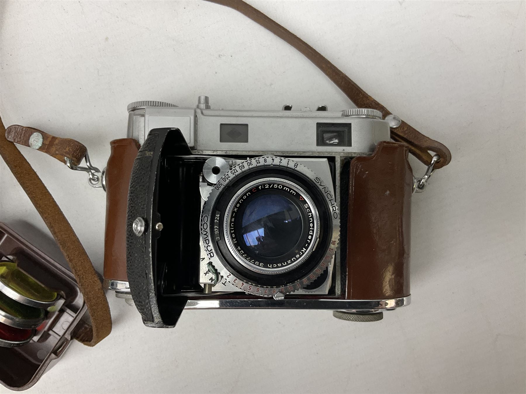 Kodak Retina III camera with 'Schneider-Kreuznach 3977724 Retina-Xenon C f:2/50mm' lens in leather case, and Brownie Model D in leather case